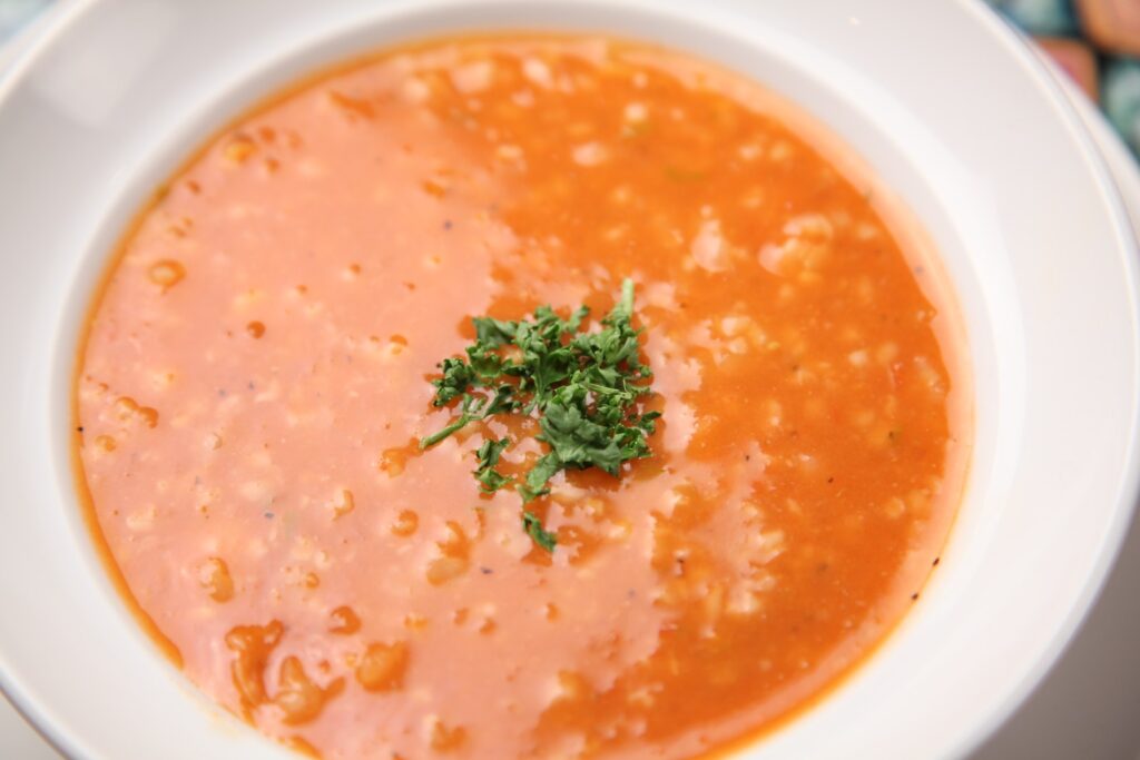 Soup With Minced Herbs on Round White Ceramic Plate